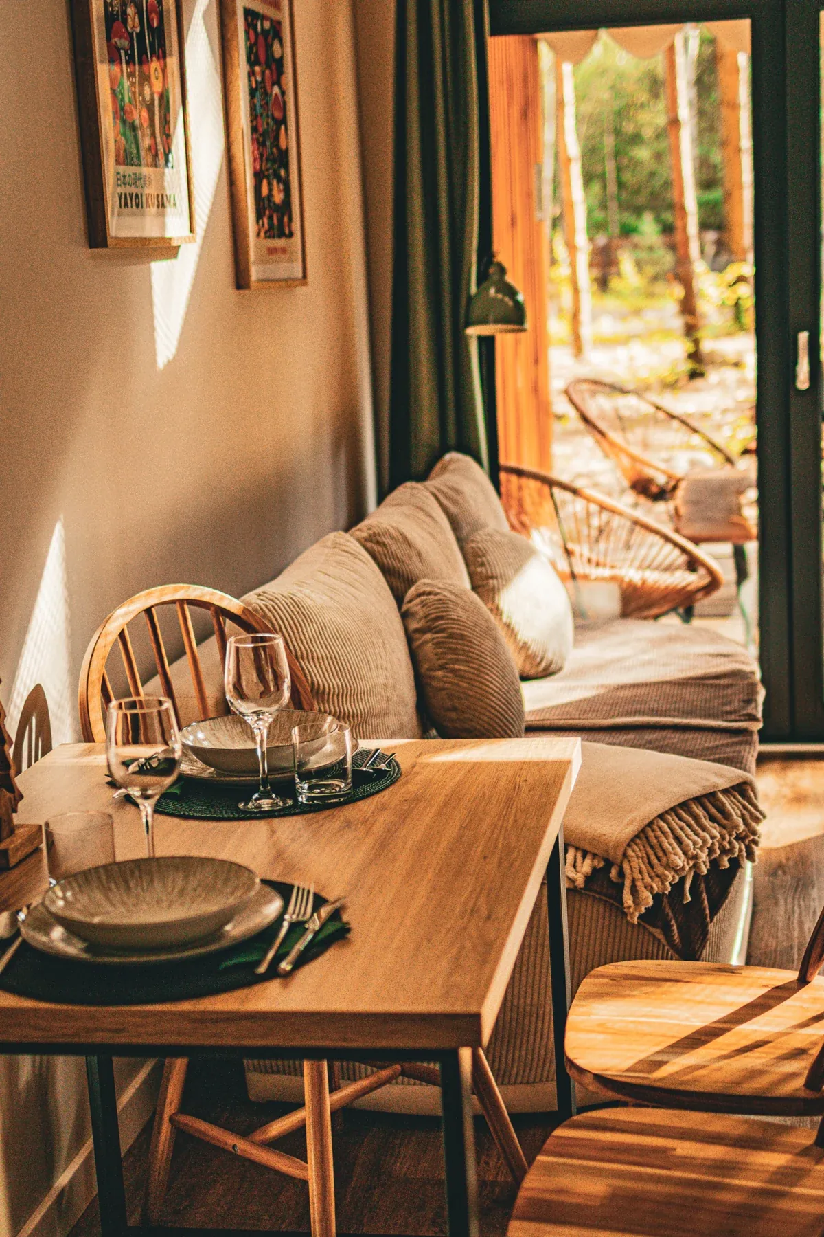 A laid table and sofa beside the terrace doors
