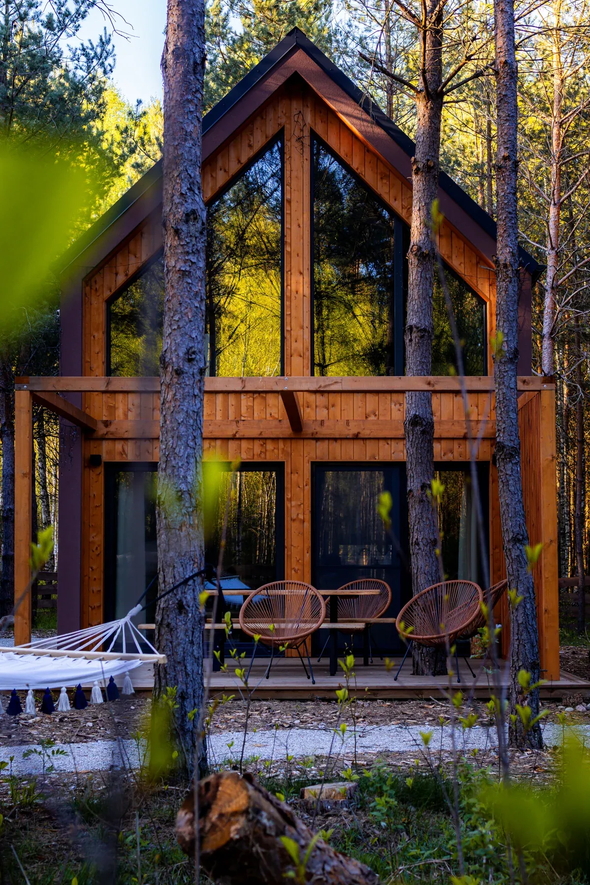 The front of a cabin between the pines
