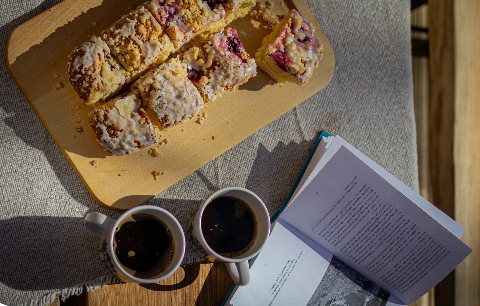 Two mugs and an open book