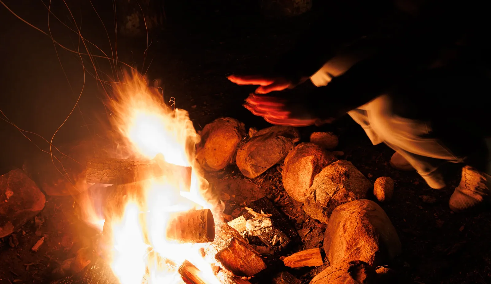 Warming hands by the campfire