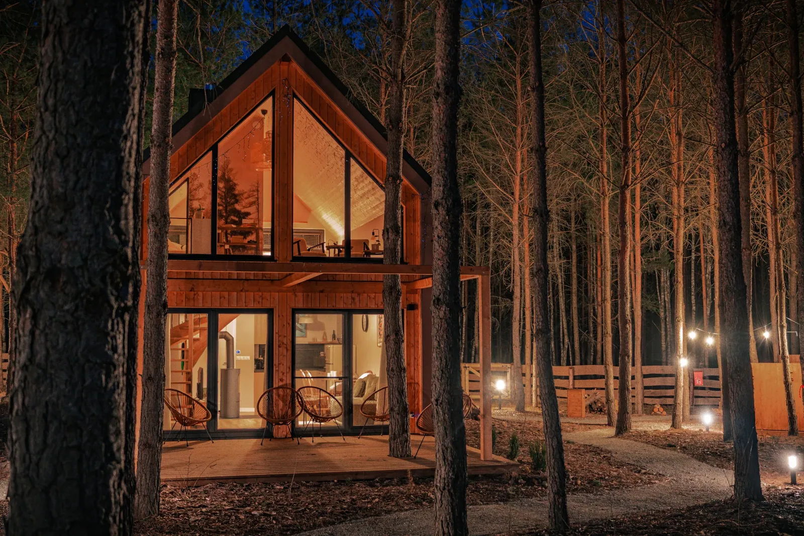 An illuminated cabin among the pines
