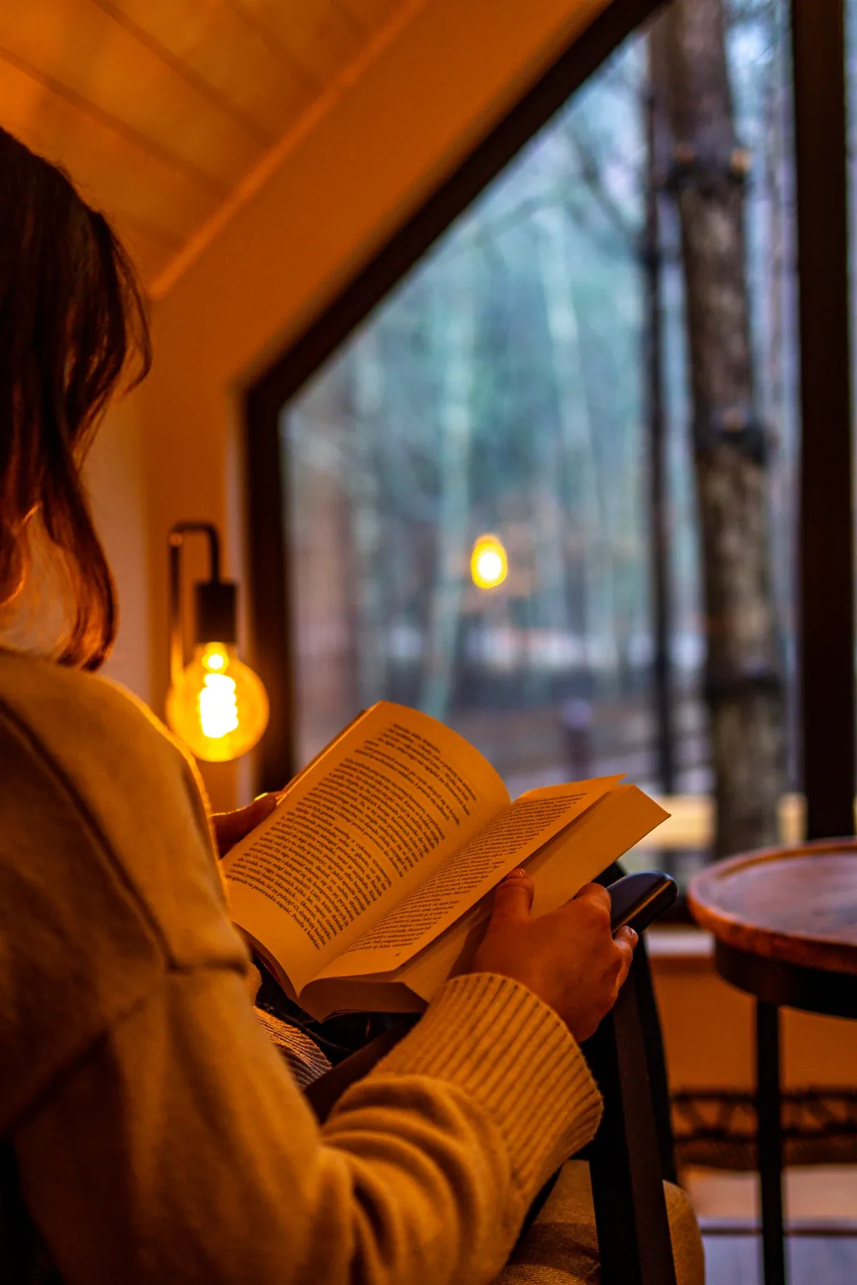 Warm light and a book beside the window