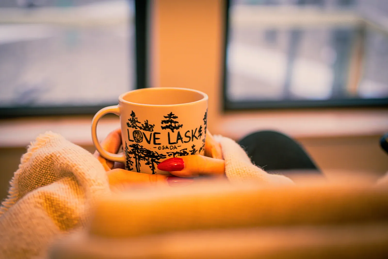 A LoveLaski mug on a warm blanket