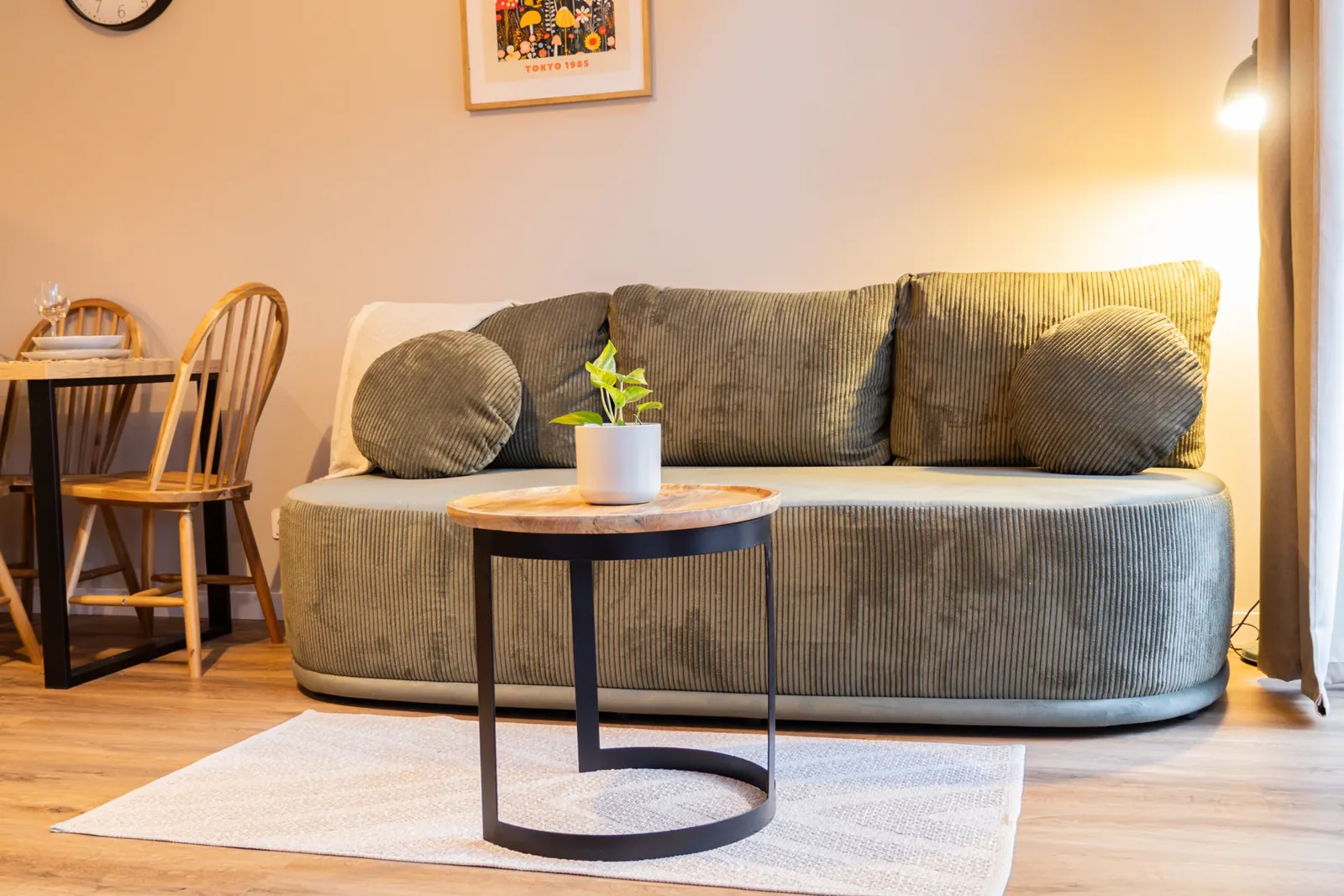A green sofa with a wooden table