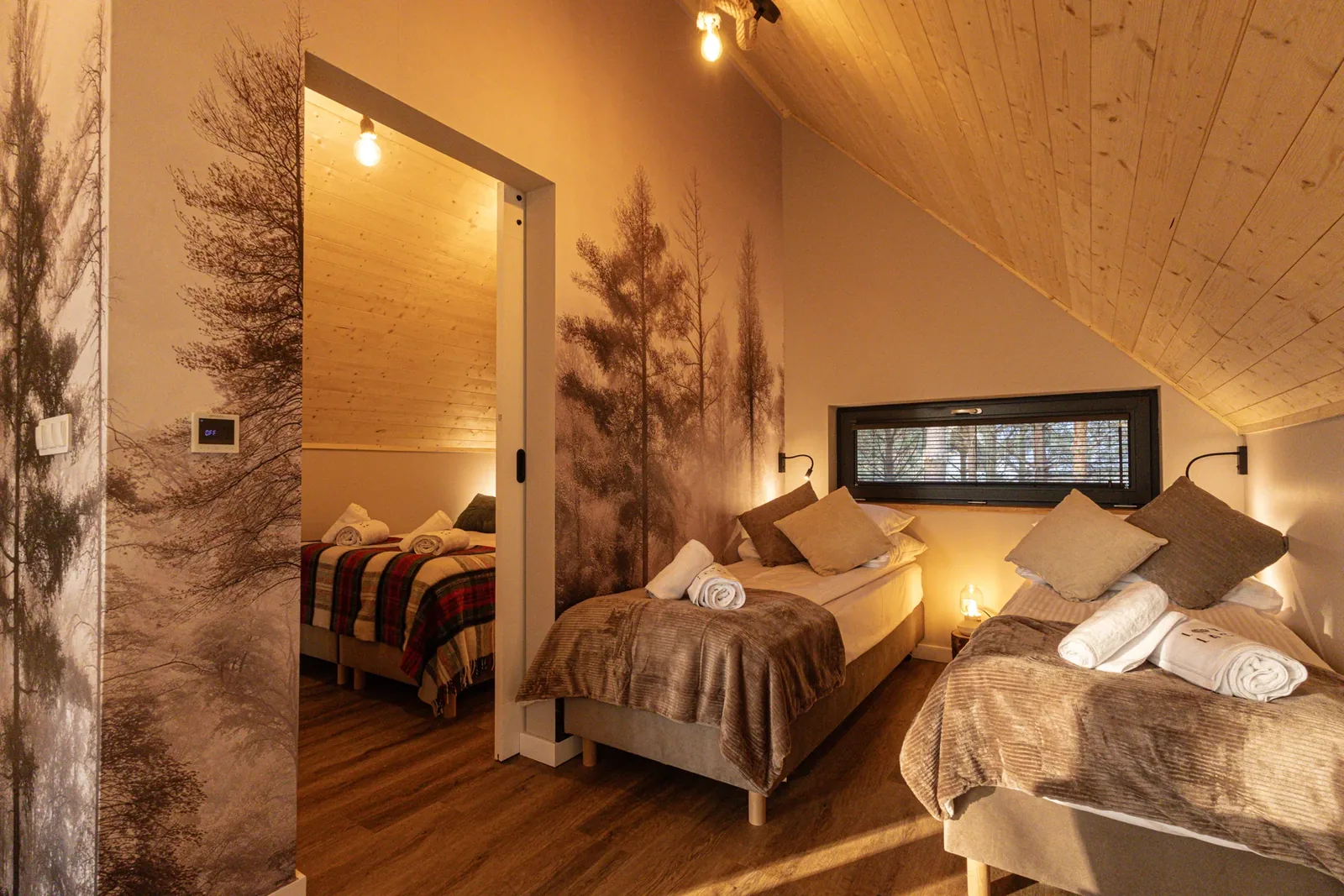 A bedroom with forest wallpaper
