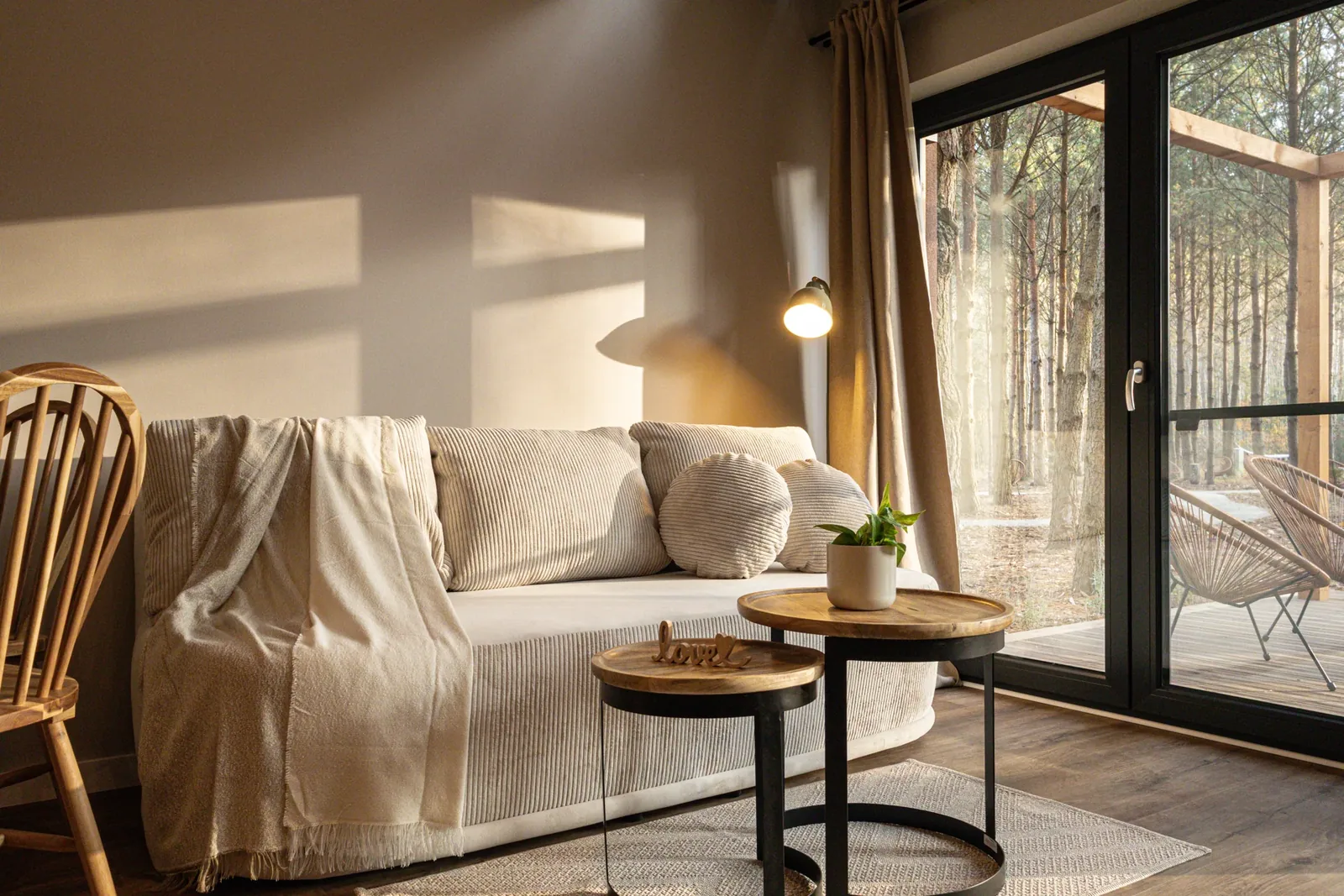 A sofa beside the glass doors overlooking the terrace