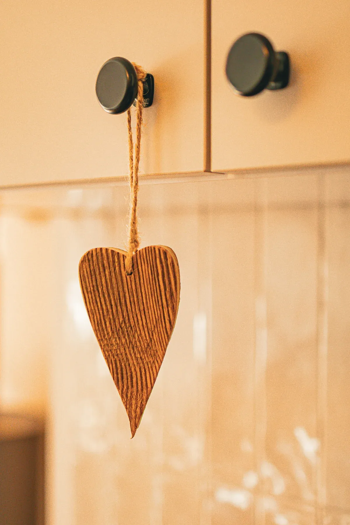A wooden heart on a coat hook