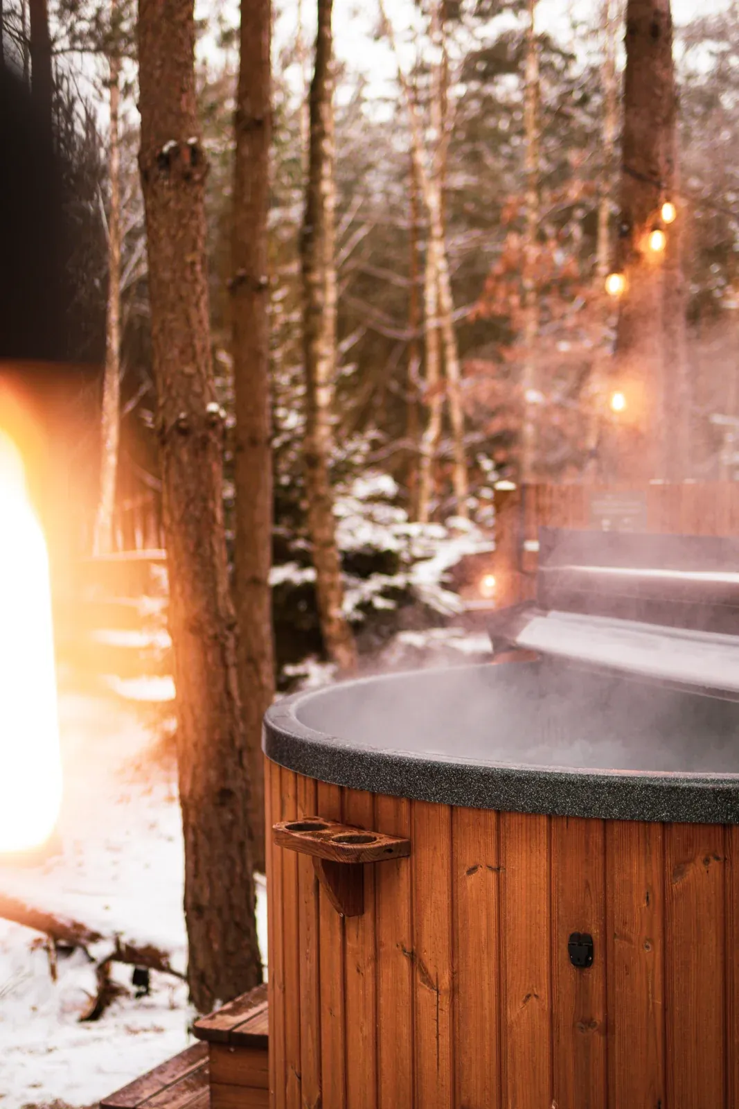 A steaming hot tub in the winter forest