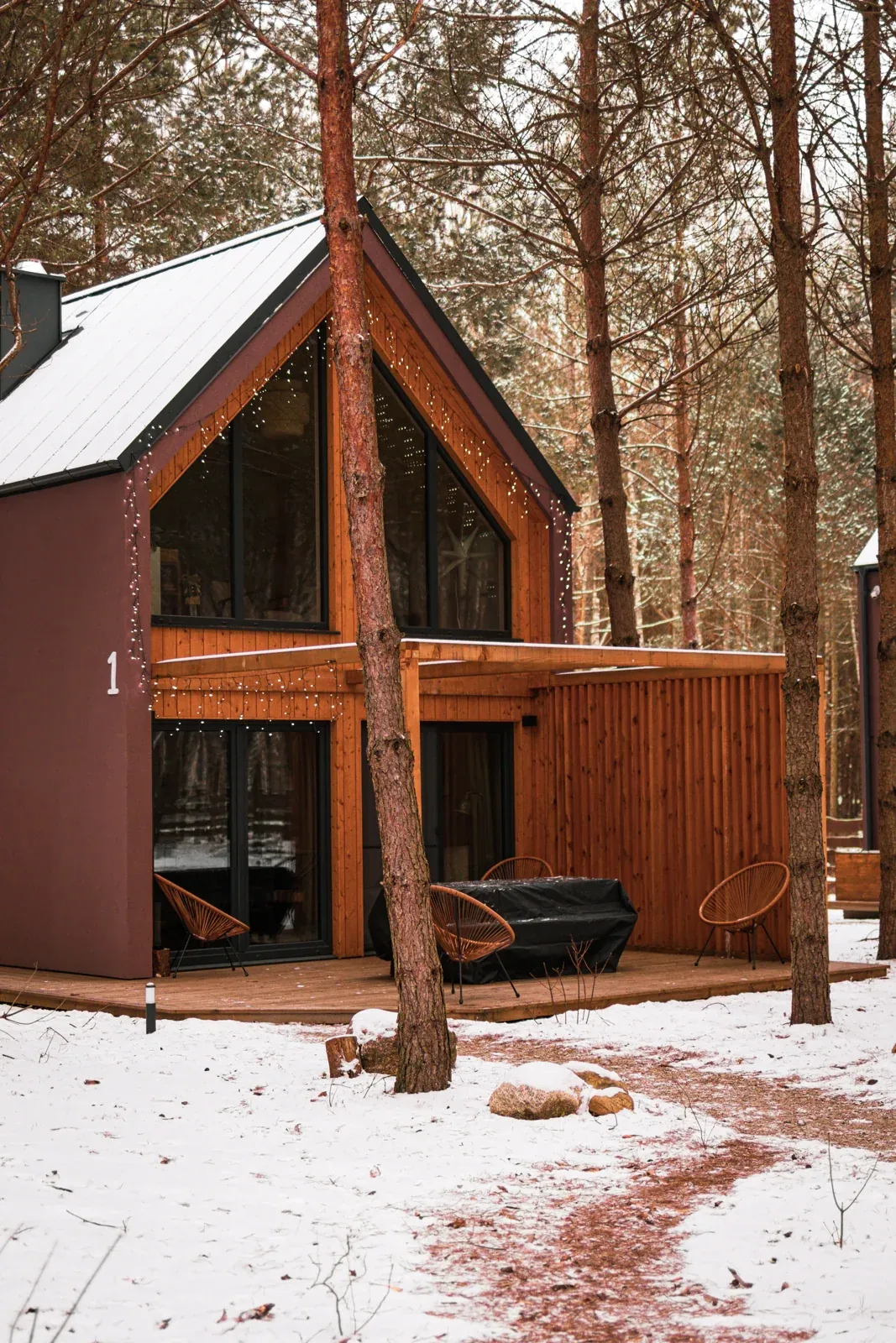 A cabin and terrace covered in snow