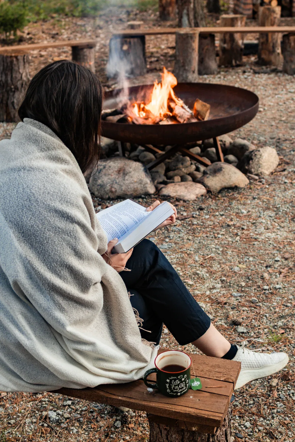 Reading a book by the campfire