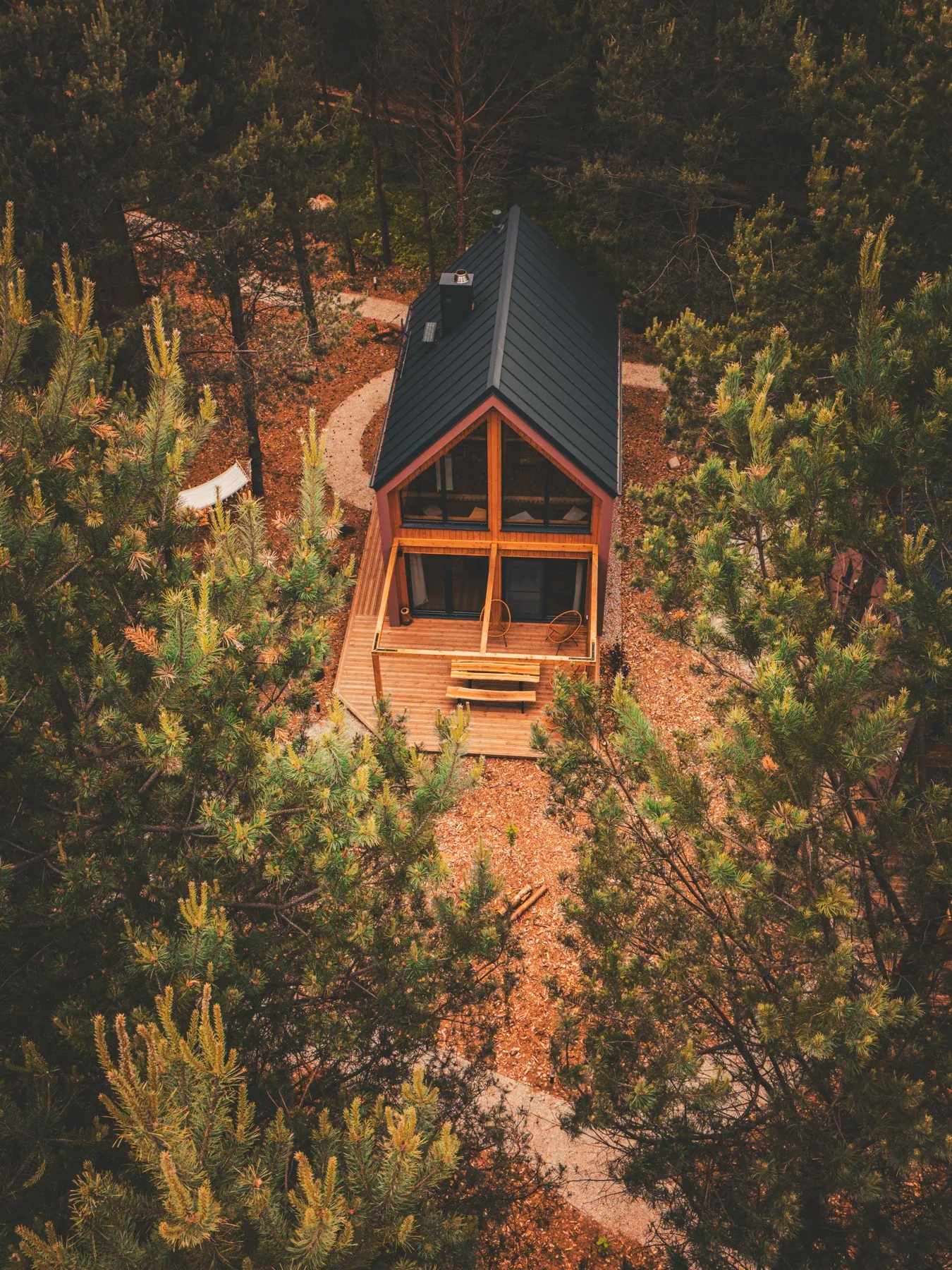 A cabin among autumn treetops