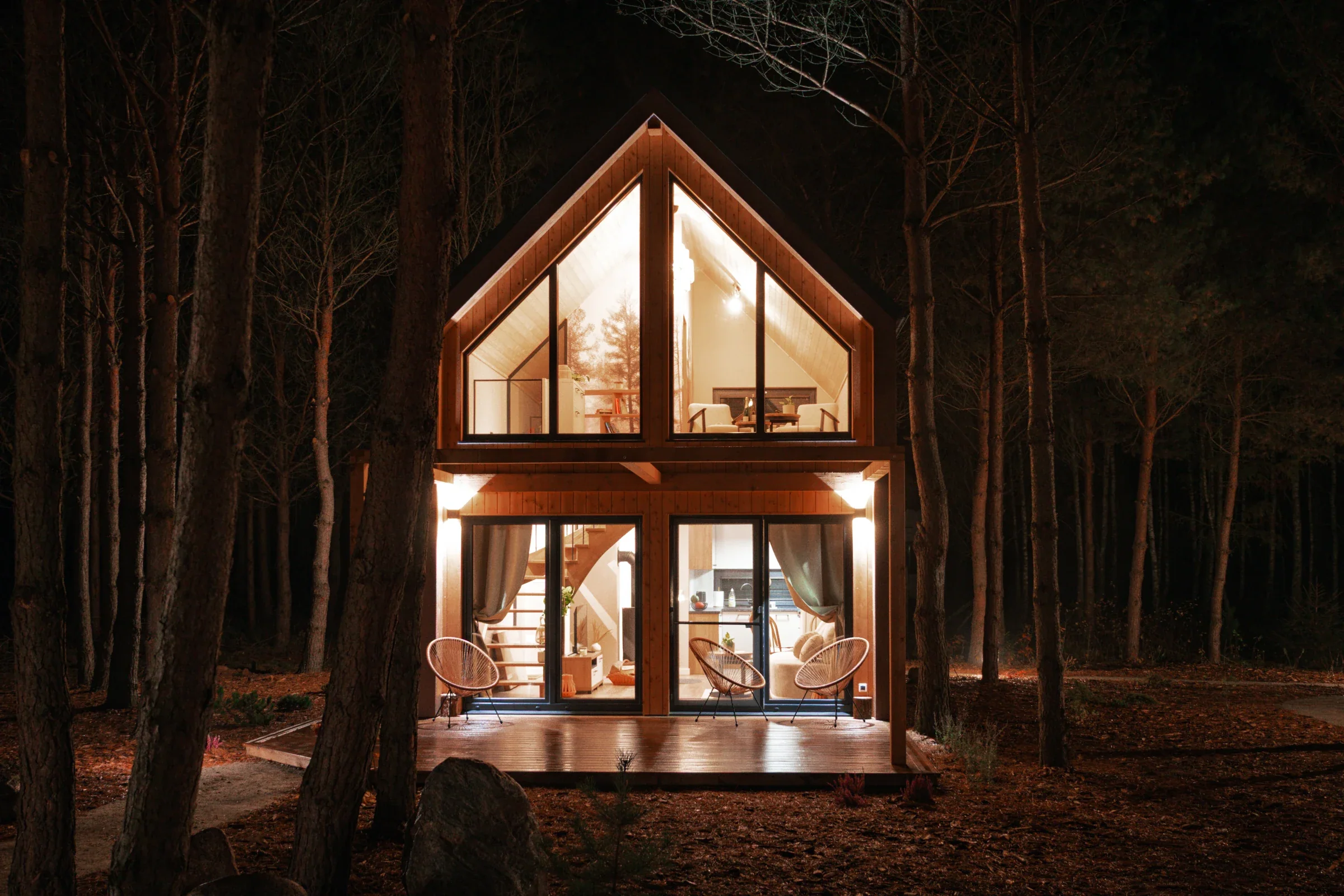 The glass front of a cabin at night
